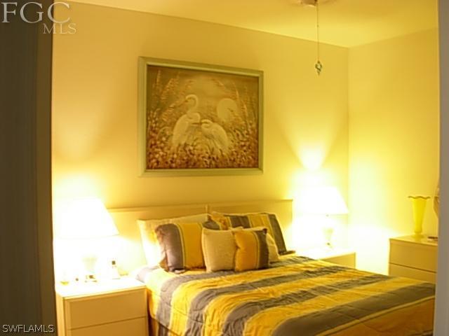 14081 Brant Point Circle, Unit 537 Fort Myers, FL 33919 - Photo 14 of 23 a bedroom with a bed and cupboard