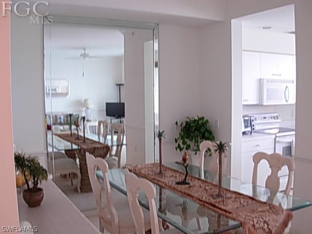14081 Brant Point Circle, Unit 537 Fort Myers, FL 33919 - Photo 7 of 23 a living room with furniture potted plant floor and a large window