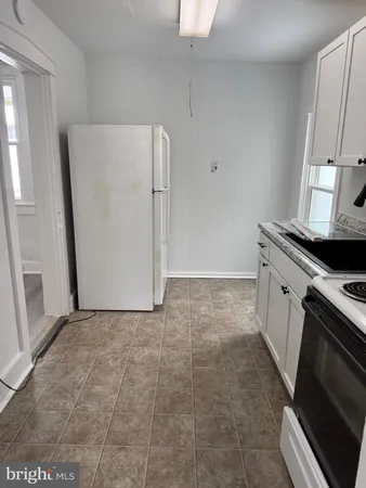 a view of a kitchen with a sink stove and cabinets