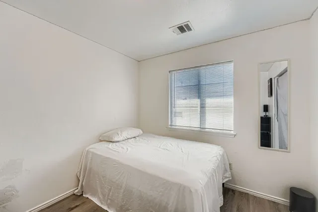 a bedroom with a bed and a mirror