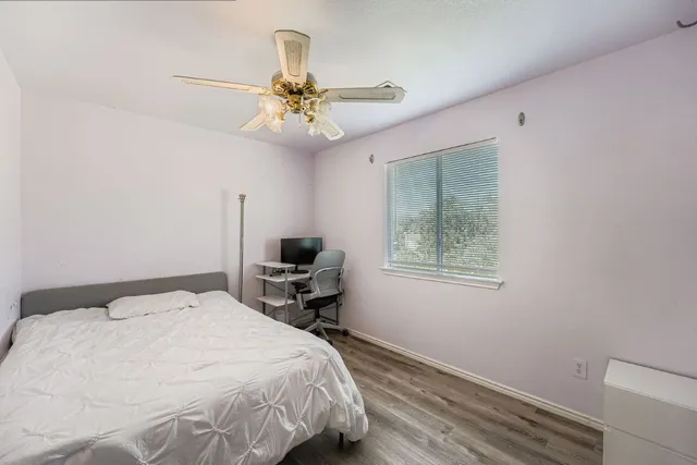 a bedroom with a bed and a window