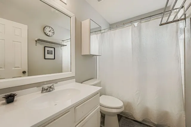 a bedroom with a bed and a chandelier fan