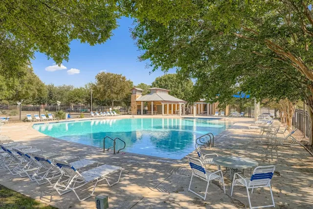 a view of a house with wooden fence
