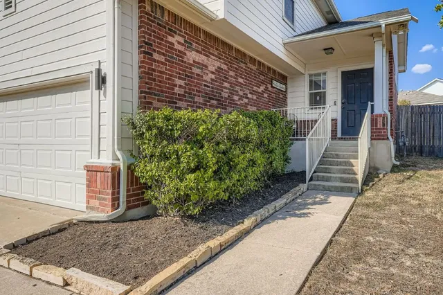 a view of a pathway along the house