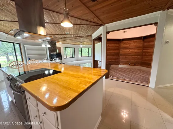 a room with pool table and windows