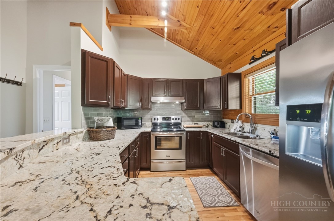 850 River Ridge Road Boone, NC 28607 - Photo 5 of 26 a kitchen with stainless steel appliances granite countertop a stove sink and cabinets