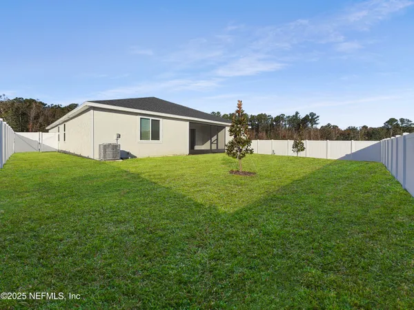 a big house with a big yard and large trees
