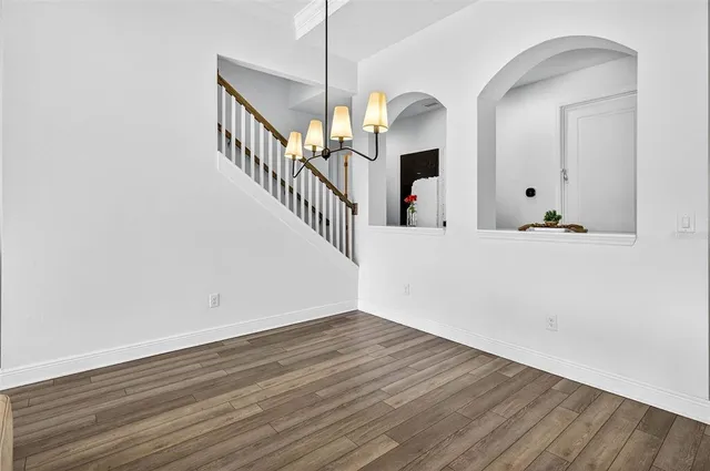 an empty room with chandelier fan