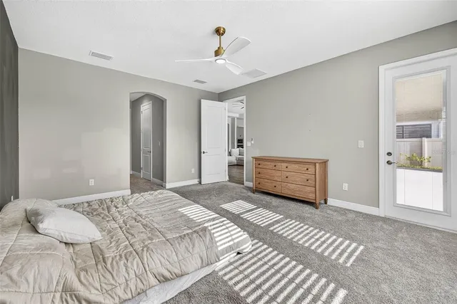 a bedroom with a bed and a chair