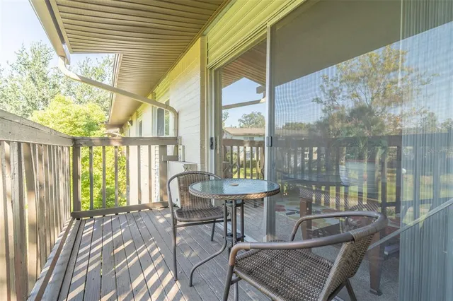 a view of a balcony with chairs and a table