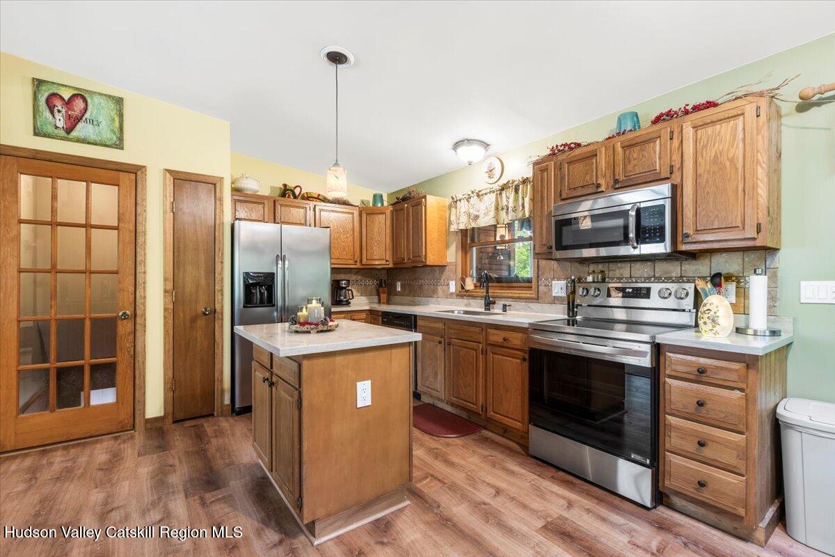 61 Travis Boulevard Catskill, NY 12414 - Photo 12 of 30 a kitchen with stainless steel appliances granite countertop a stove top oven a sink and a refrigerator