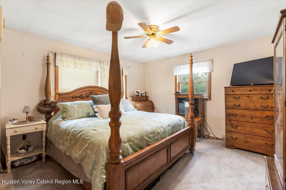 61 Travis Boulevard Catskill, NY 12414 - Photo 13 of 30 a bedroom with a bed and a chandelier