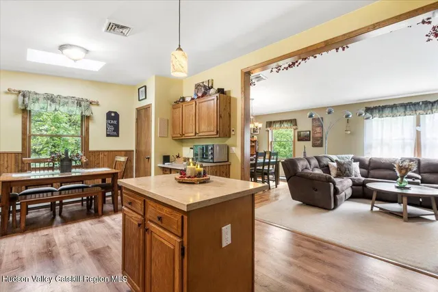 a view of a kitchen counter top space with furniture and wooden floor