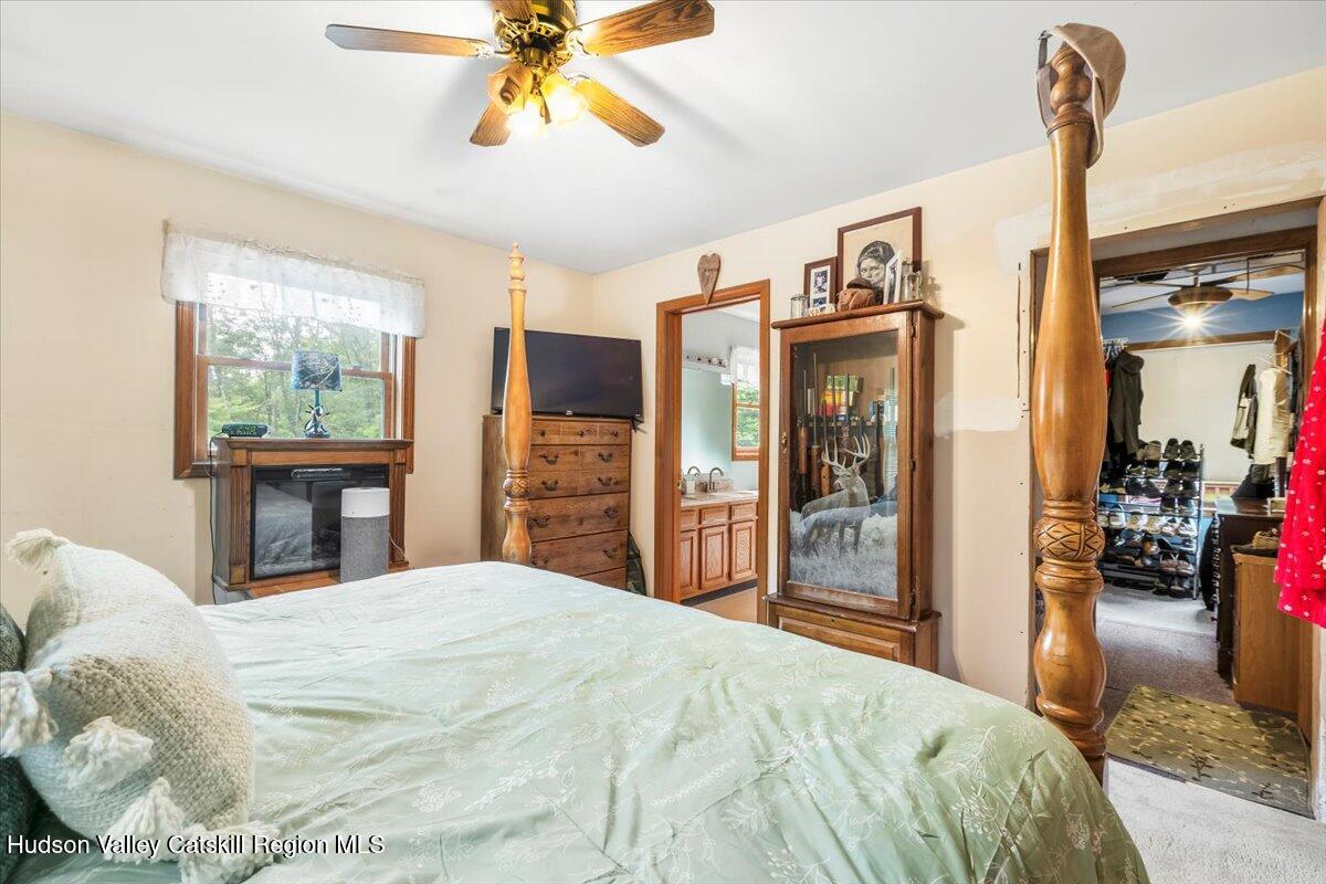 61 Travis Boulevard Catskill, NY 12414 - Photo 17 of 30 a bedroom with a bed and a chandelier