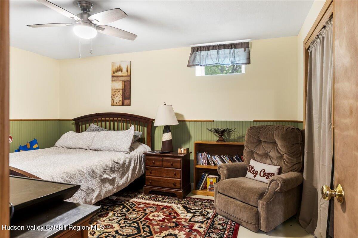 61 Travis Boulevard Catskill, NY 12414 - Photo 19 of 30 a bedroom with a bed and ceiling fan