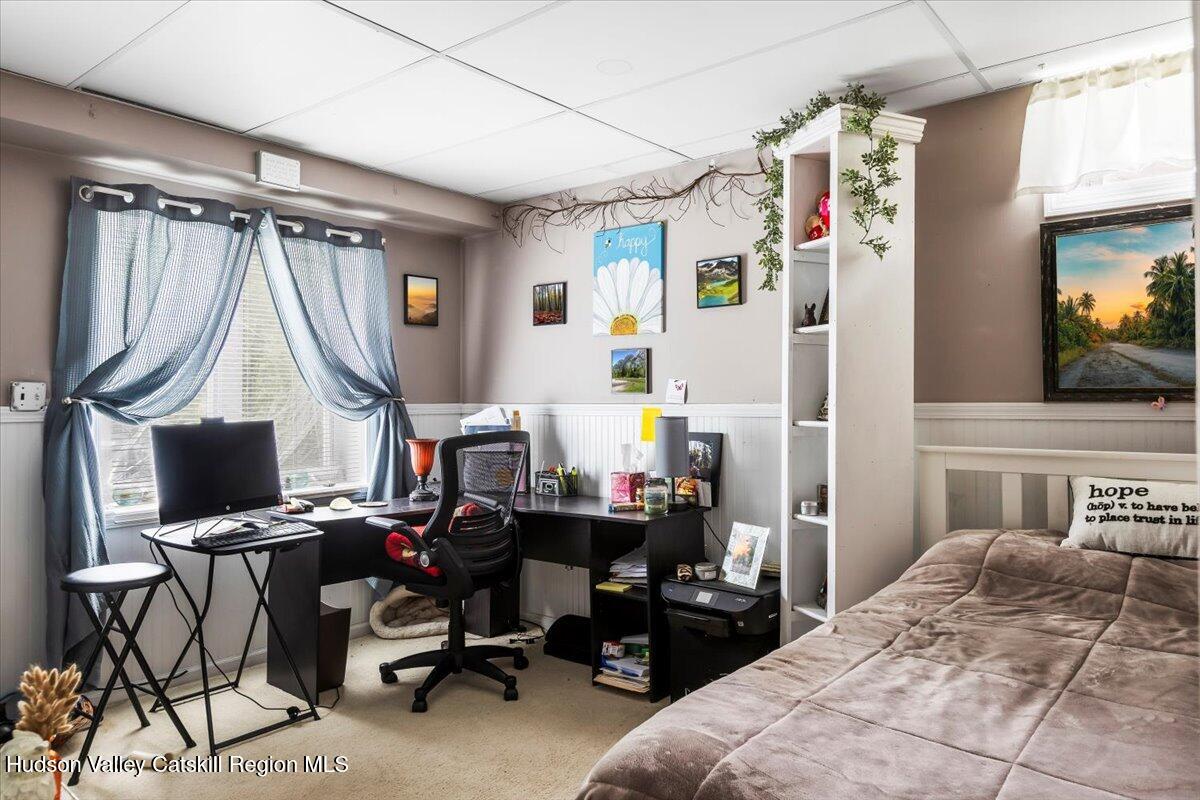 61 Travis Boulevard Catskill, NY 12414 - Photo 21 of 30 a bedroom with a bed a computer on the desk and a desk