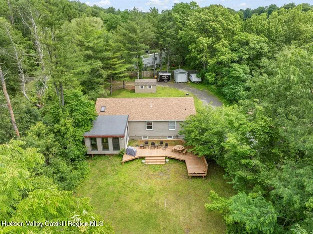 a view of house with backyard and garden