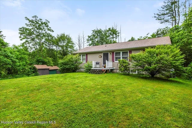 a view of a garden with a building in the background