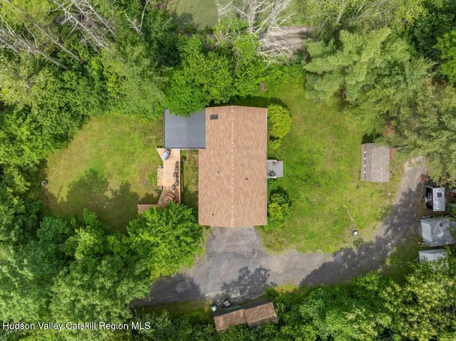 an aerial view of a house with pool garden and lake view