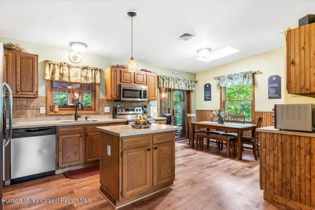 a open kitchen with stainless steel appliances granite countertop a stove and refrigerator