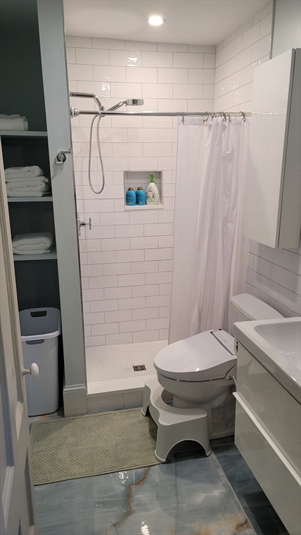 55 Buffum Street, Unit 2 Salem, MA 01970 - Photo 3 of 10 a bathroom with a sink and a toilet