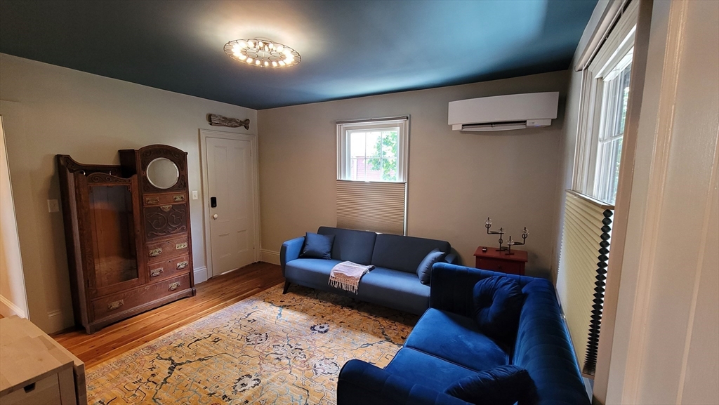 55 Buffum Street, Unit 2 Salem, MA 01970 - Photo 5 of 11 a living room with furniture and a gate