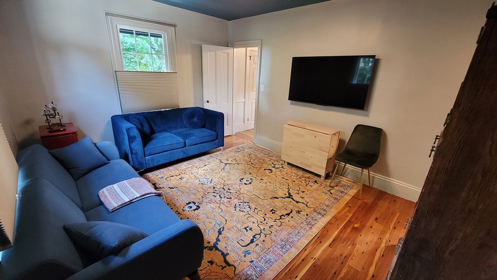 55 Buffum Street, Unit 2 Salem, MA 01970 - Photo 5 of 10 a living room with furniture and a flat screen tv
