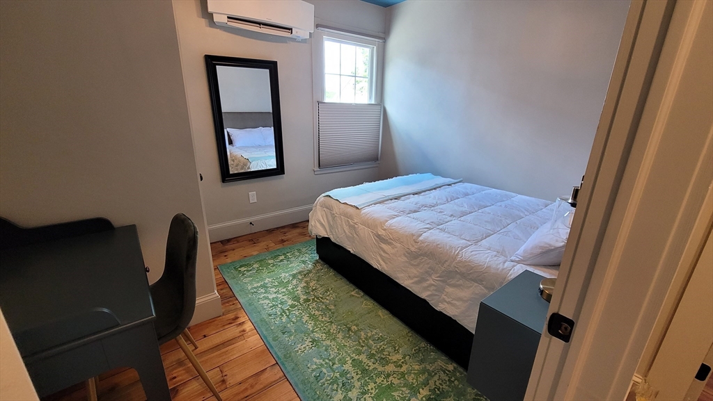 55 Buffum Street, Unit 2 Salem, MA 01970 - Photo 7 of 10 a bedroom with a bed dresser and a window