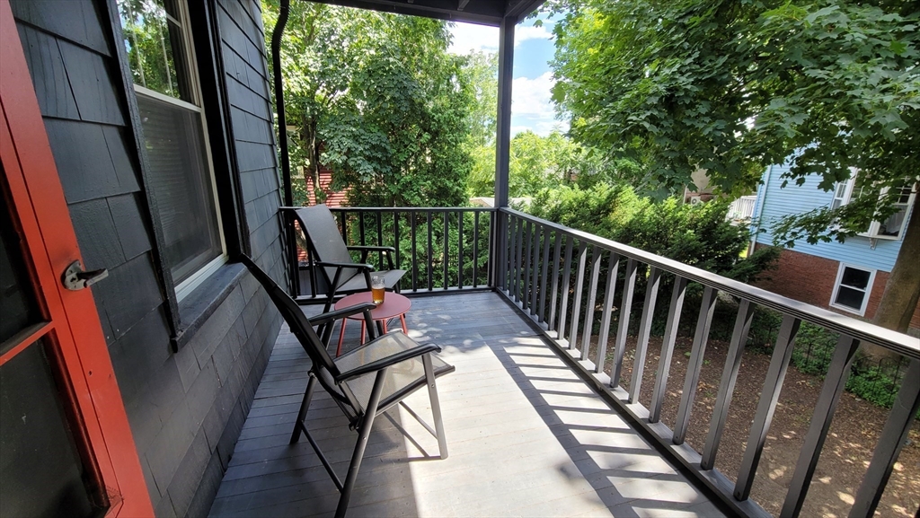 55 Buffum Street, Unit 2 Salem, MA 01970 - Photo 10 of 11 a view of balcony with wooden floor and outdoor seating