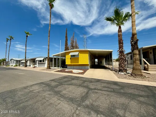 a view of a house with a patio and a yard
