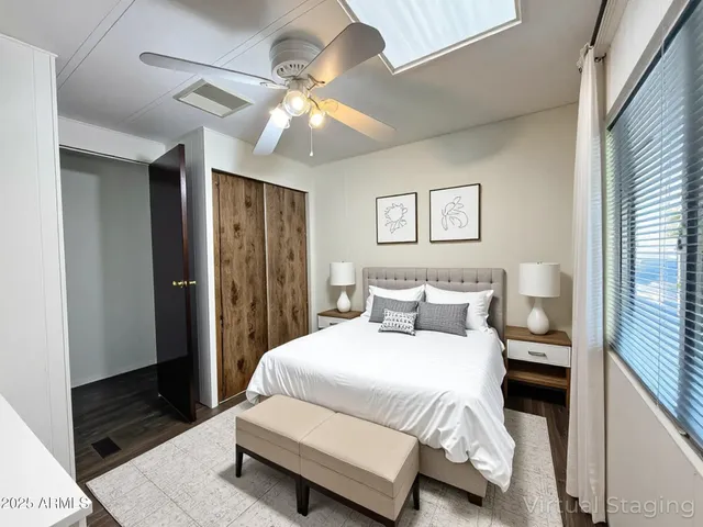 a bedroom with a large bed and a chandelier