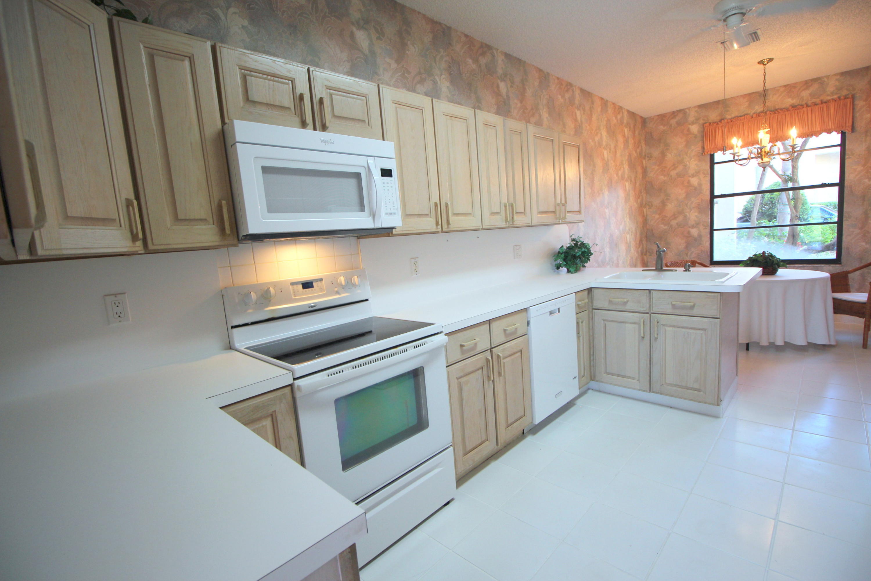 23475 Water Circle Boca Raton, FL 33486 - Photo 13 of 32 a kitchen with cabinets appliances and a window