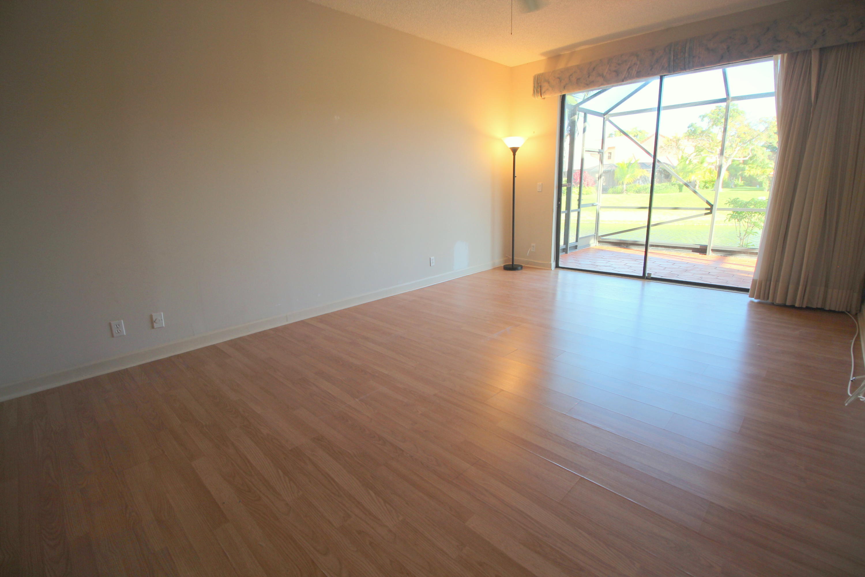 23475 Water Circle Boca Raton, FL 33486 - Photo 17 of 32 an empty room with wooden floor and windows