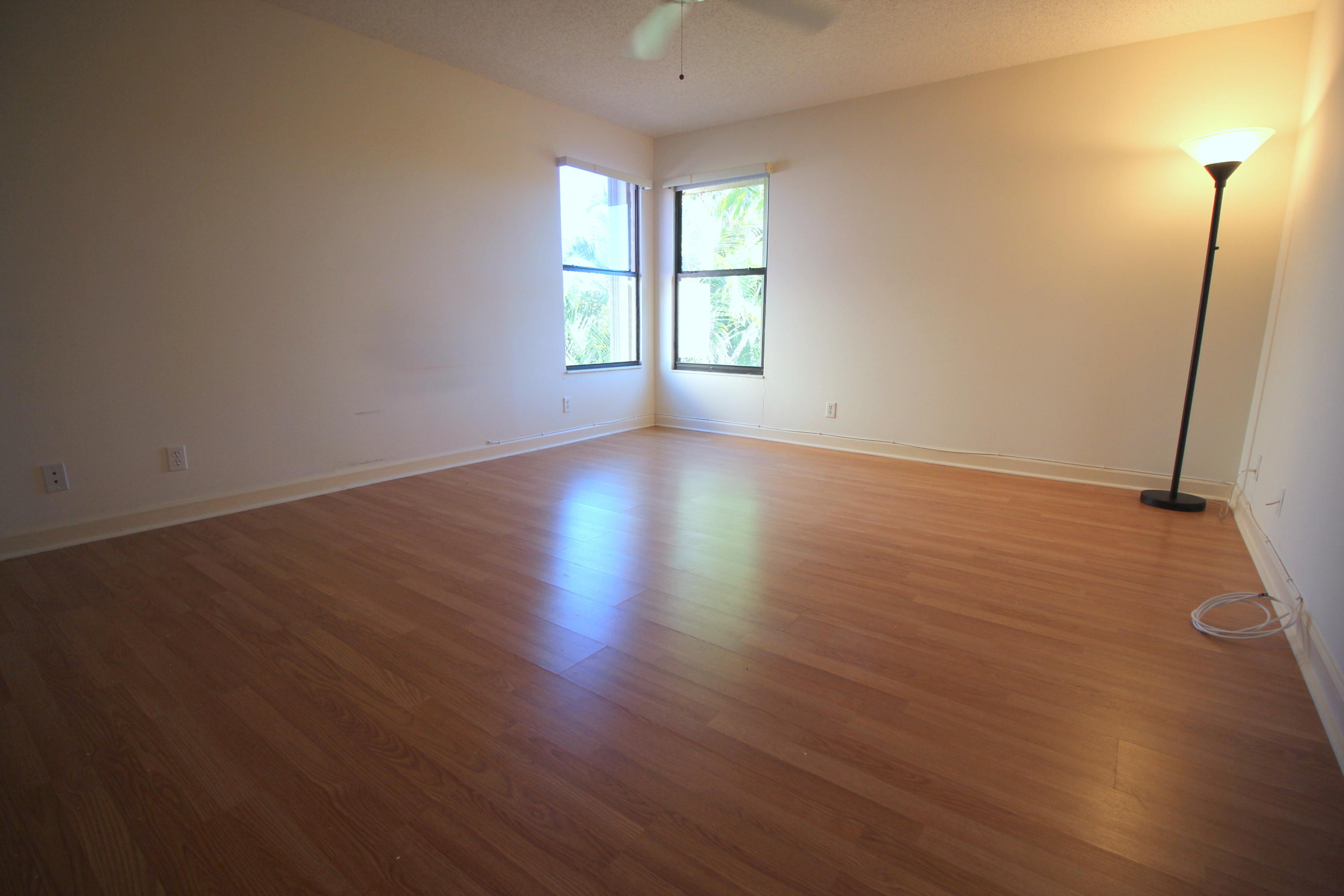 23475 Water Circle Boca Raton, FL 33486 - Photo 24 of 32 an empty room with wooden floor and window