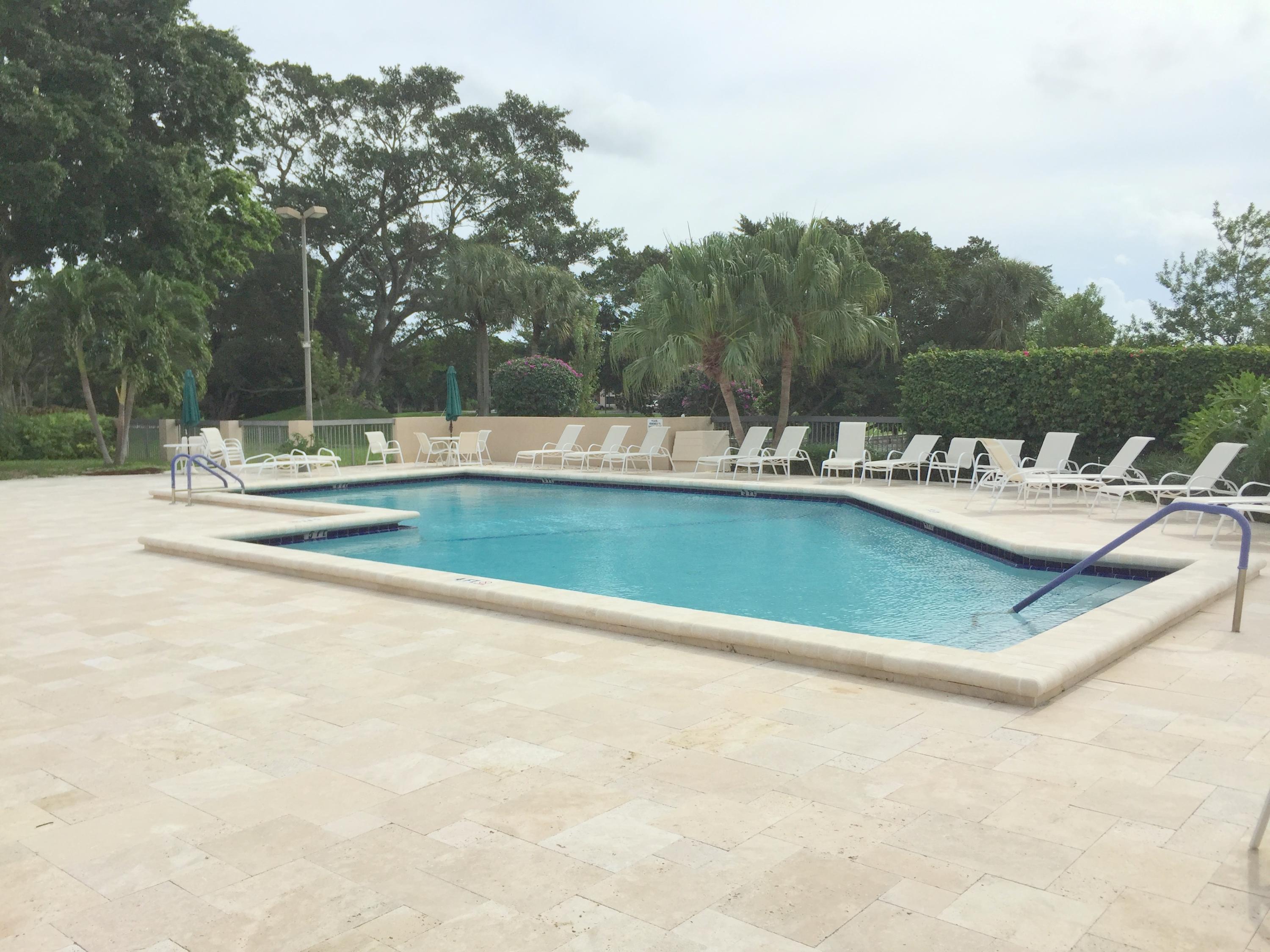23475 Water Circle Boca Raton, FL 33486 - Photo 28 of 32 a view of a swimming pool and lounge chairs