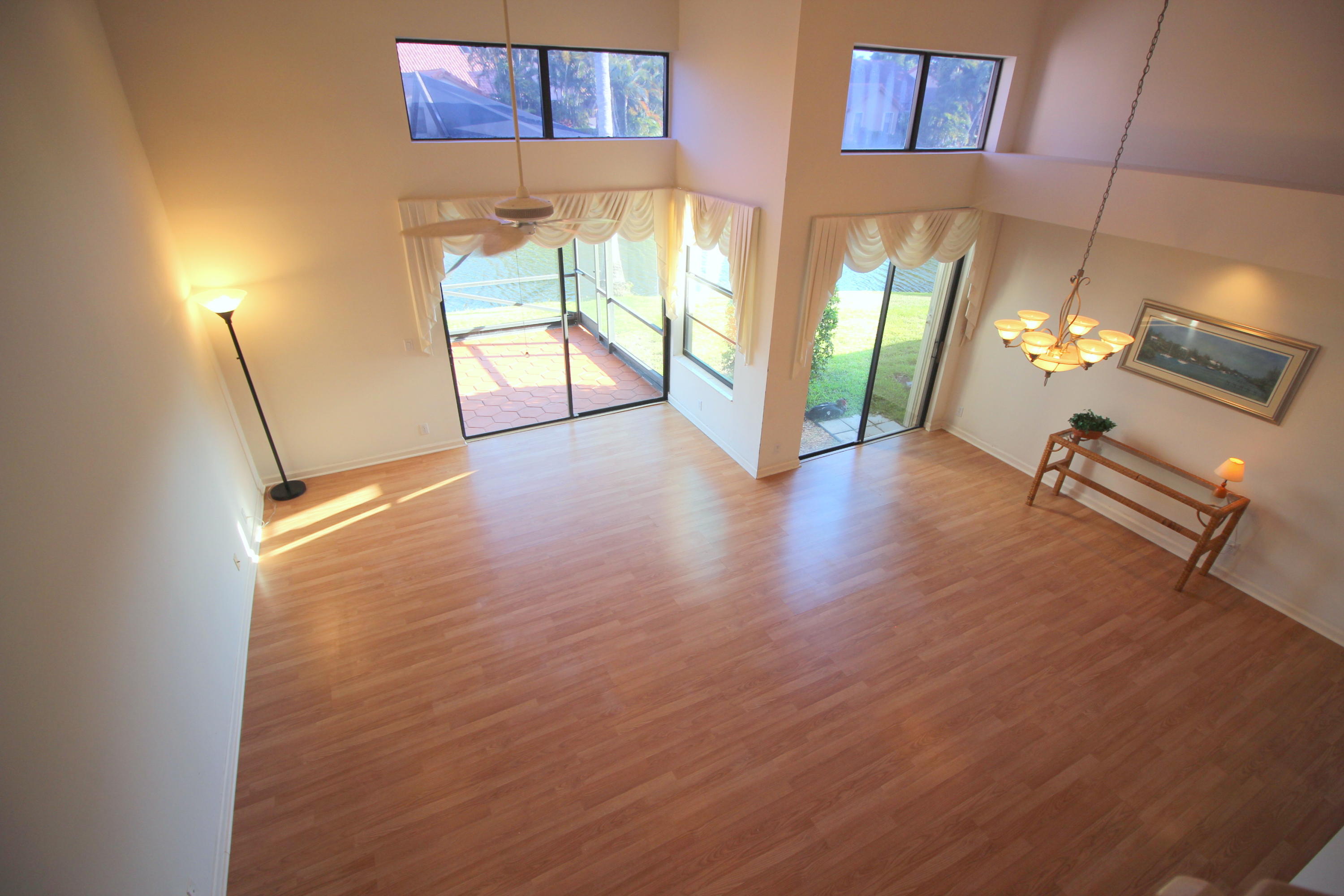 23475 Water Circle Boca Raton, FL 33486 - Photo 9 of 32 a view of an empty room with a fireplace and wooden floor