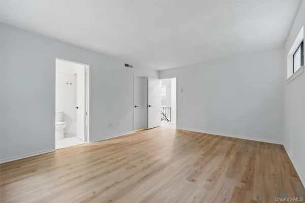 a view of an empty room and wooden floor
