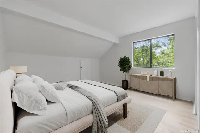 a bedroom with a bed and a large window