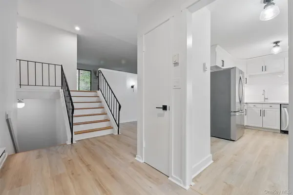 a view of a kitchen with wooden floor and electronic appliances