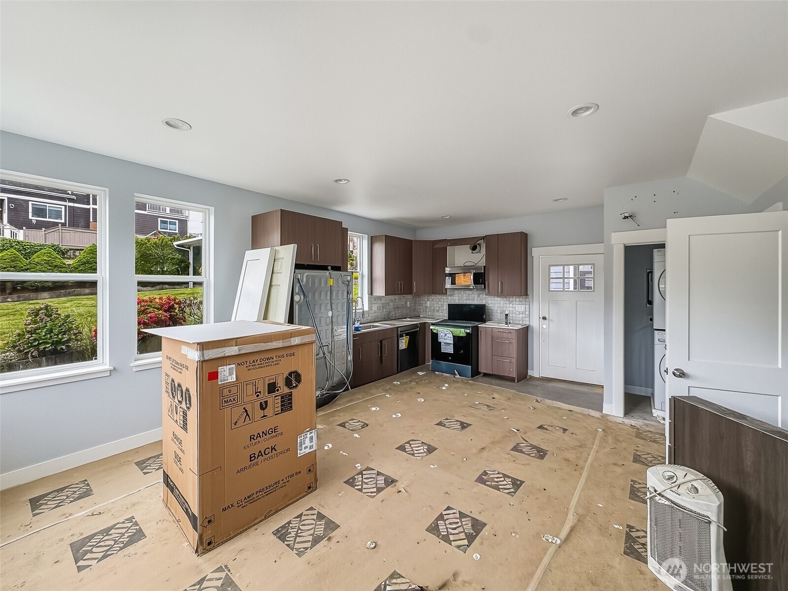 2317 22nd Avenue South Seattle, WA 98144 - Photo 16 of 29 a view of kitchen with stainless steel appliances granite countertop a stove top oven a sink dishwasher and cabinets with wooden floor
