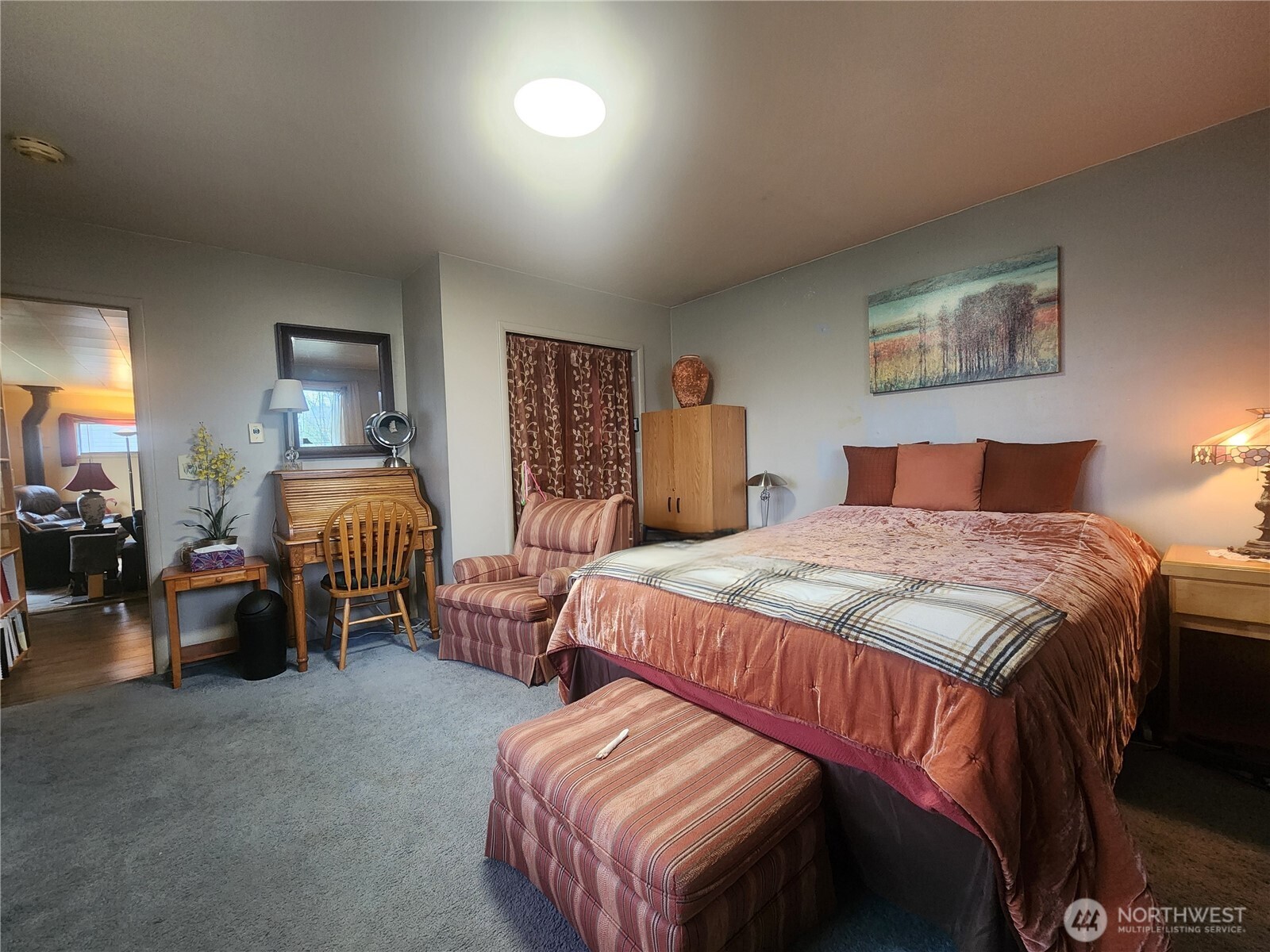 117 J Street Cosmopolis, WA 98537 - Photo 21 of 33 a bedroom with a bed and a chandelier