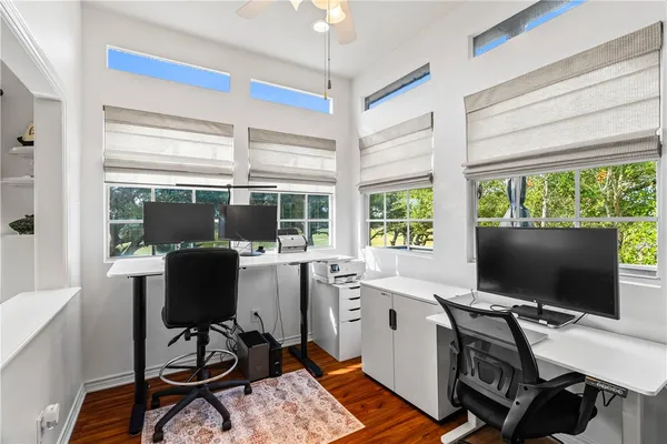 a view of a workspace with furniture and a window