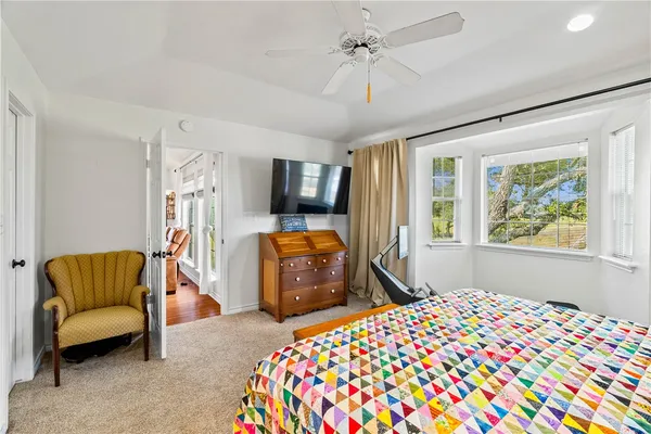 a bedroom with a bed couch and a window