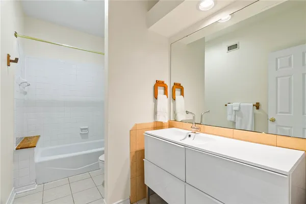 a bathroom with a tub and a sink