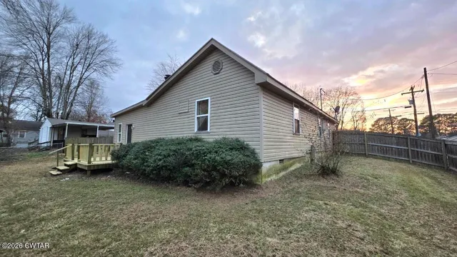 a view of a house with a yard and plants