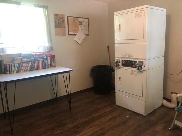 a room with a wooden floor and white walls