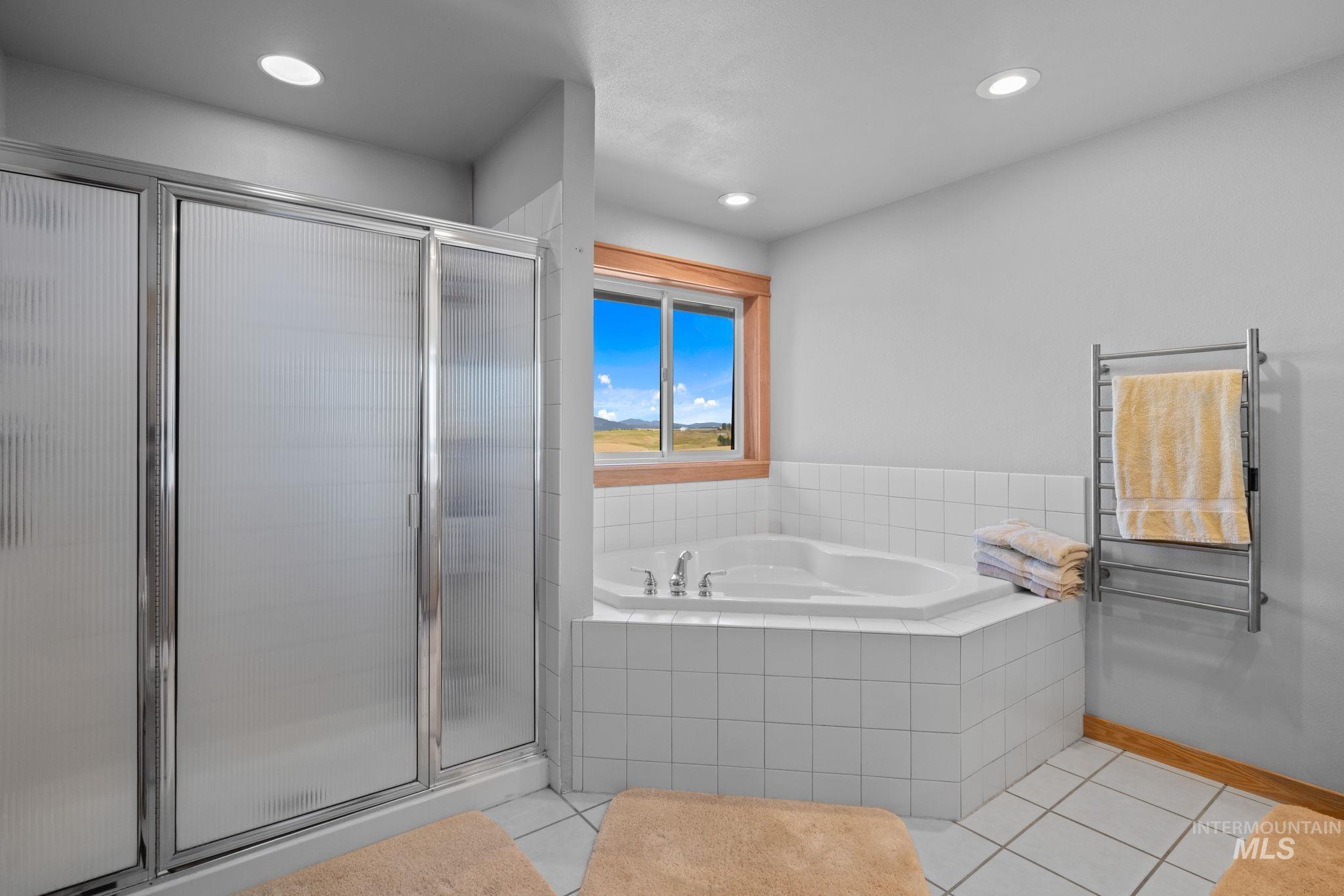 1199 Walker Road Viola, ID 83872 - Photo 18 of 50 Full bathroom featuring tile patterned floors, a garden tub, a stall shower, radiator heating unit, and recessed lighting