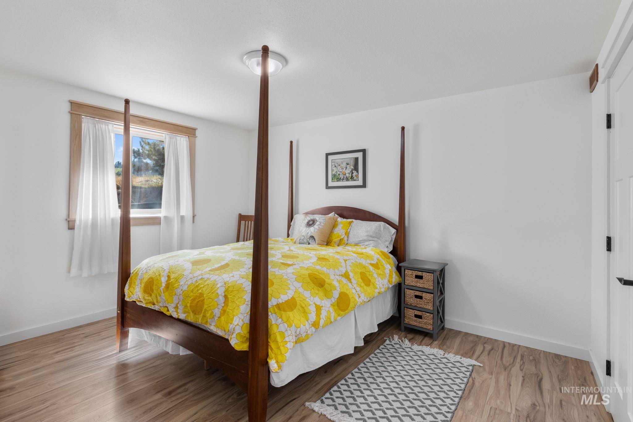 1199 Walker Road Viola, ID 83872 - Photo 23 of 50 Bedroom with wood finished floors and baseboards