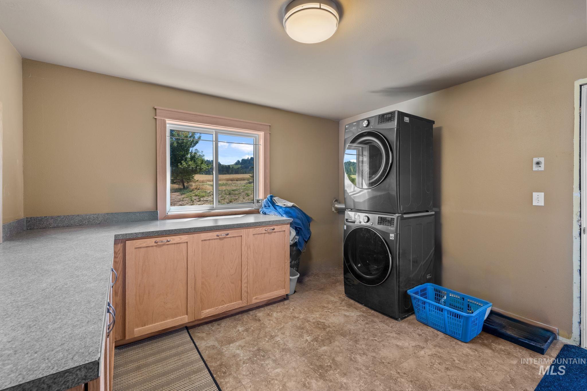 1199 Walker Road Viola, ID 83872 - Photo 28 of 50 Washroom featuring stacked washer / dryer and cabinet space