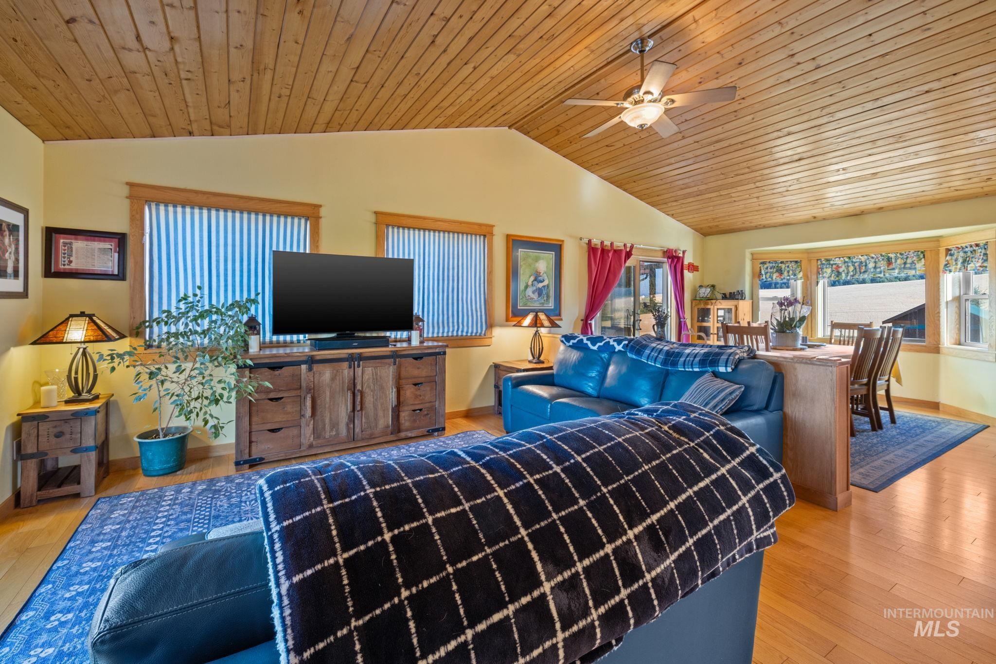 1199 Walker Road Viola, ID 83872 - Photo 7 of 50 Living area featuring vaulted ceiling, ceiling fan, healthy amount of natural light, wood ceiling, and wood finished floors